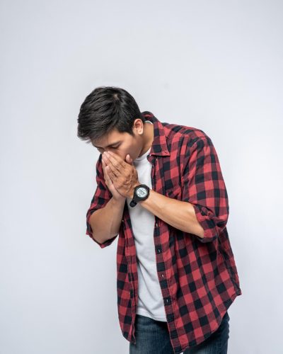 man-coughing-covering-her-mouth-with-her-hand (1)
